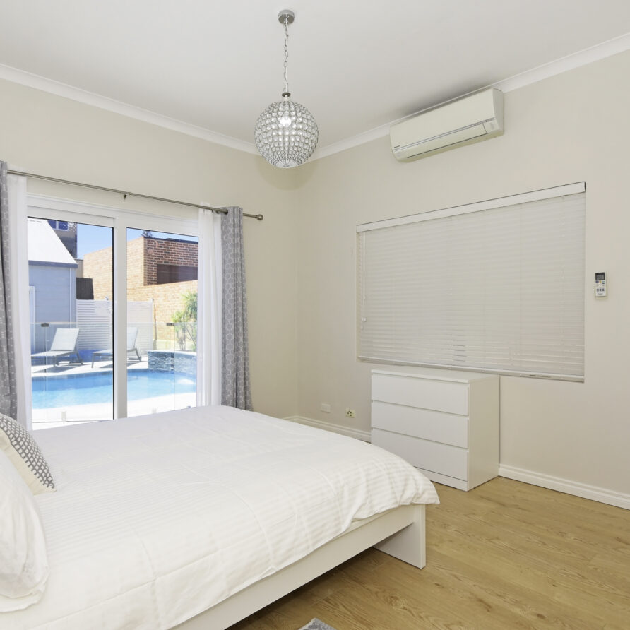 Bedroom three on ground level has sliding doors to access pool area  perth holiday stays Bedroom three on ground level has sliding doors to access pool area