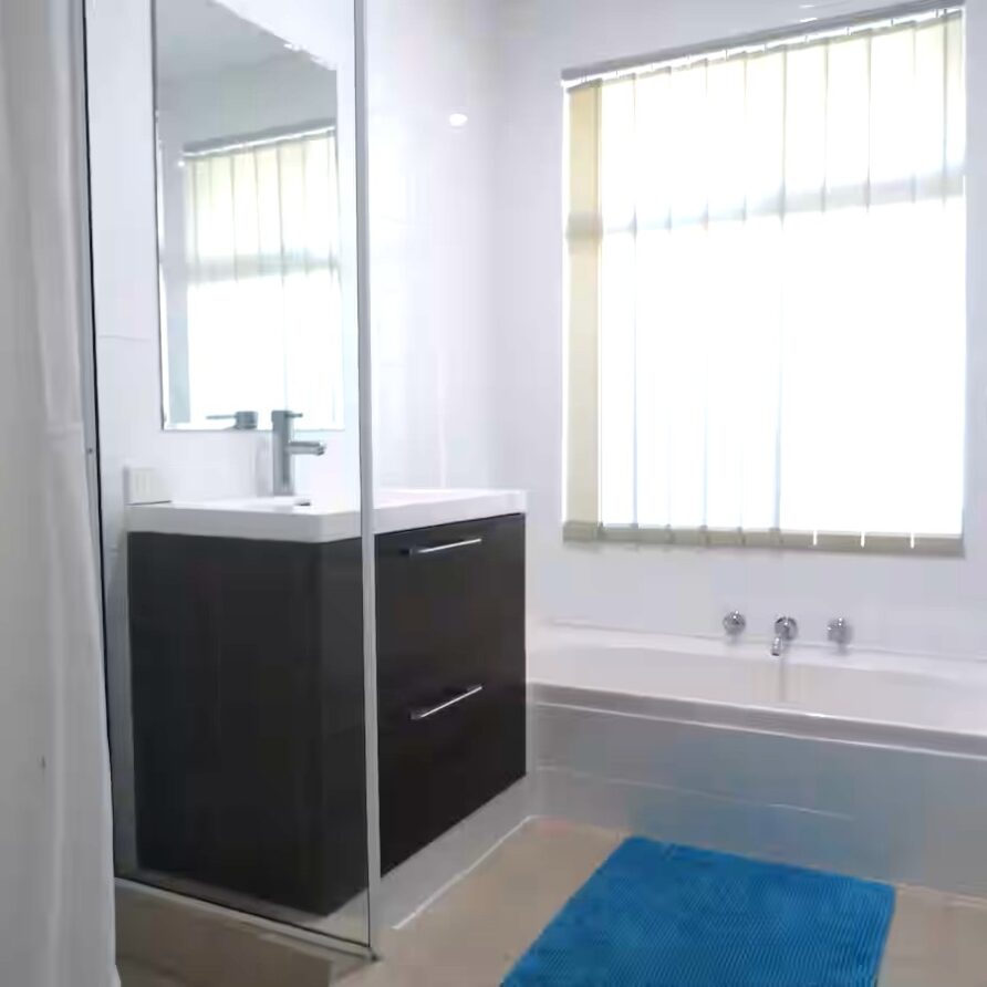 Family bathroom with bath vanity and shower  perth holiday stays Family bathroom